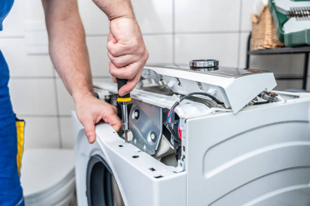Technician repairing a household appliance